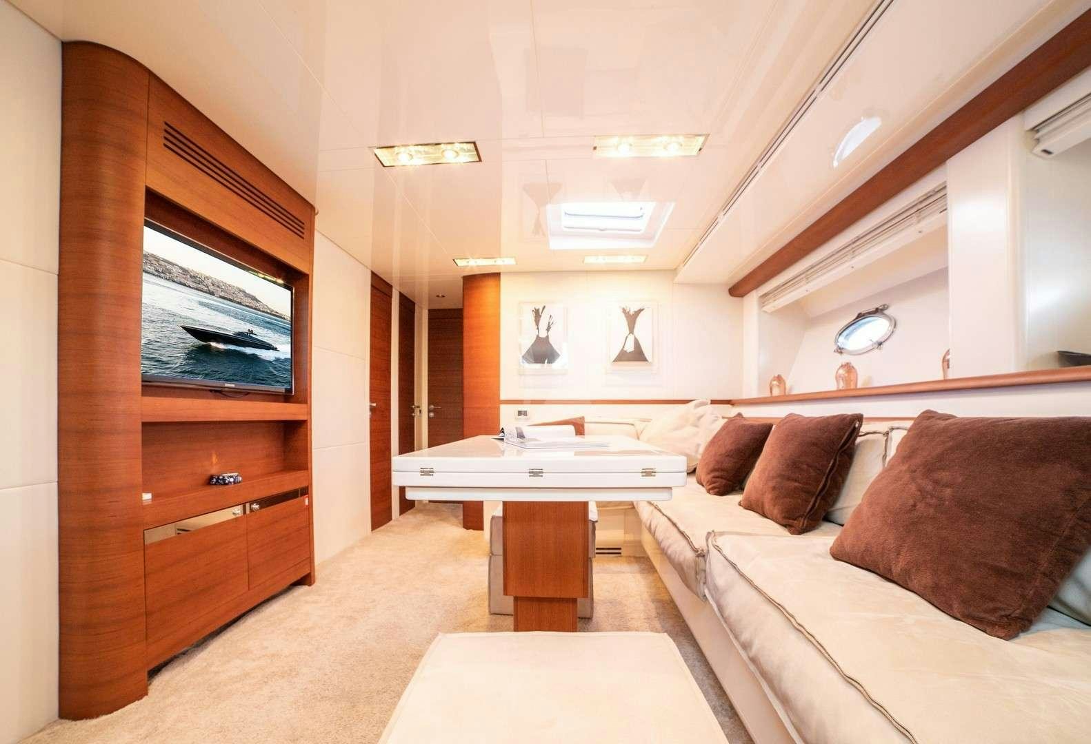 a living room with a couch and a table aboard BLUE MAMBA Yacht for Charter