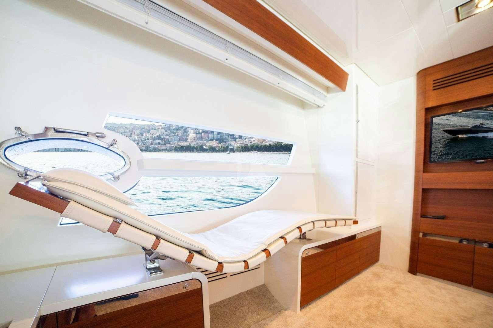 a room with a bed and a chair aboard BLUE MAMBA Yacht for Charter
