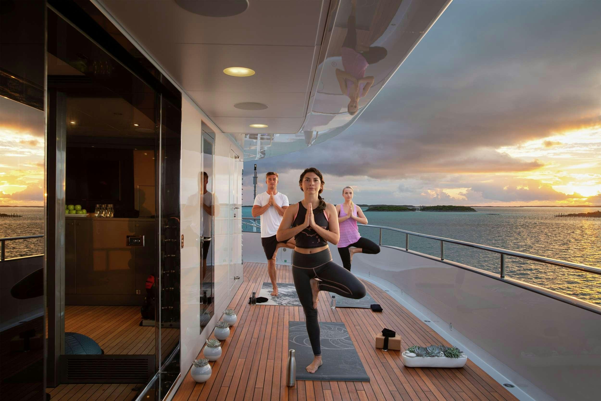 a group of people running on a boardwalk by the water aboard ETERNITY Yacht for Charter
