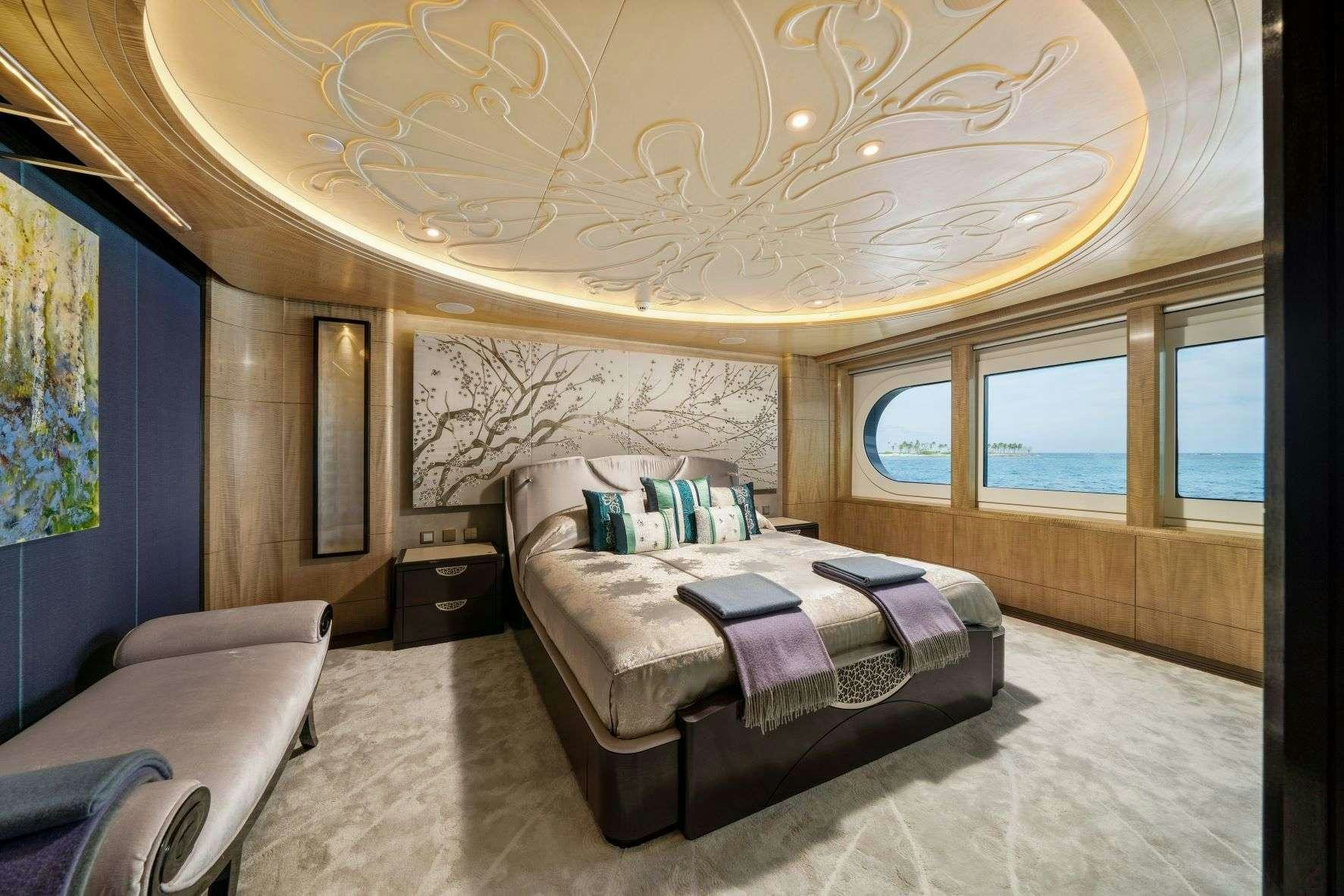 a bedroom with a large chandelier aboard AMARYLLIS Yacht for Charter