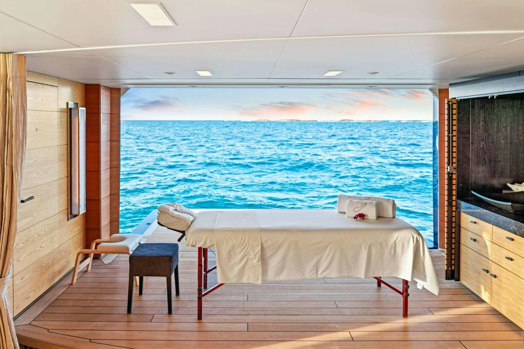 a room with a bed and a large blue ocean aboard AMARYLLIS Yacht for Charter