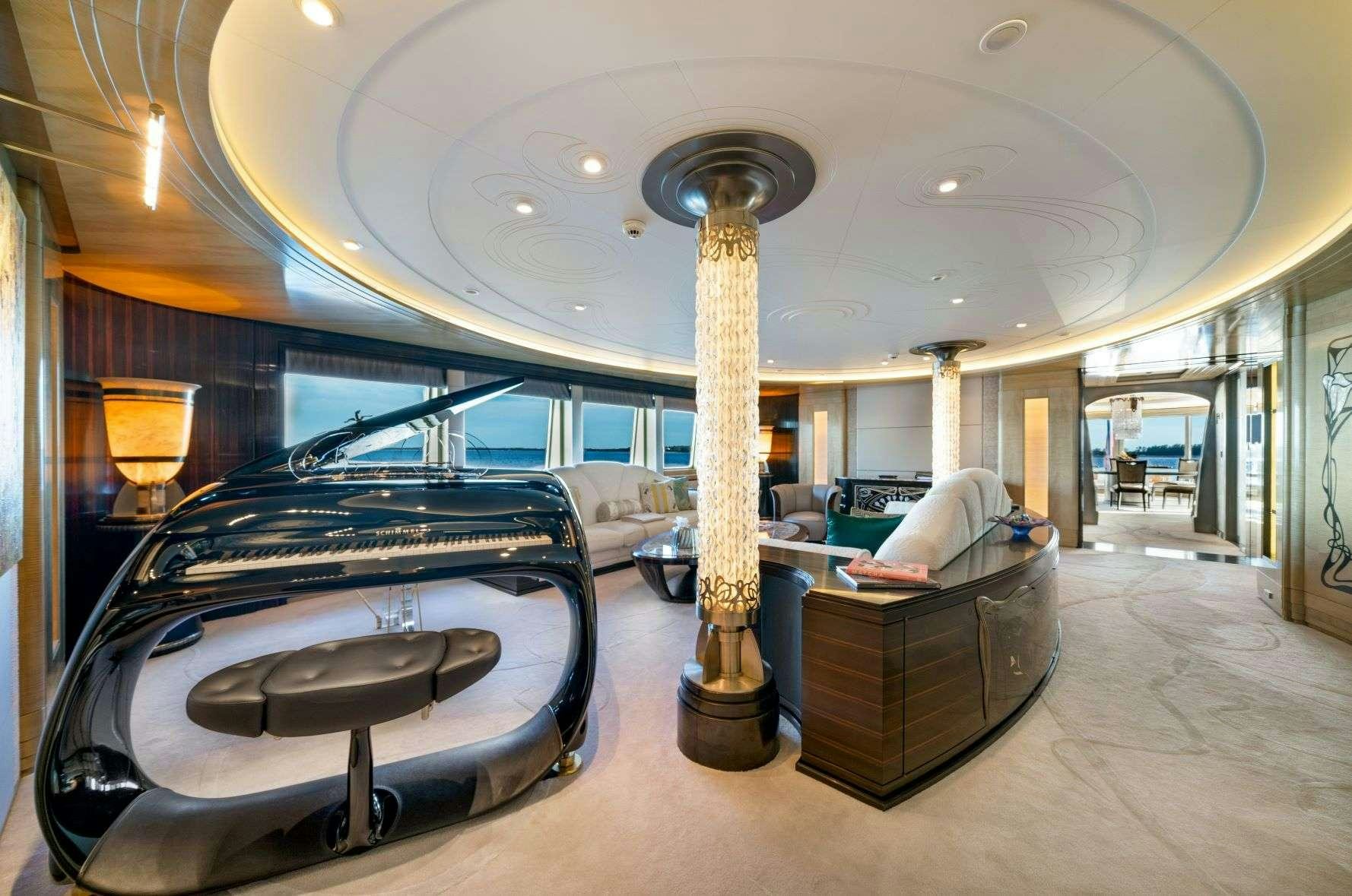 a large room with a bed and a large table aboard AMARYLLIS Yacht for Charter