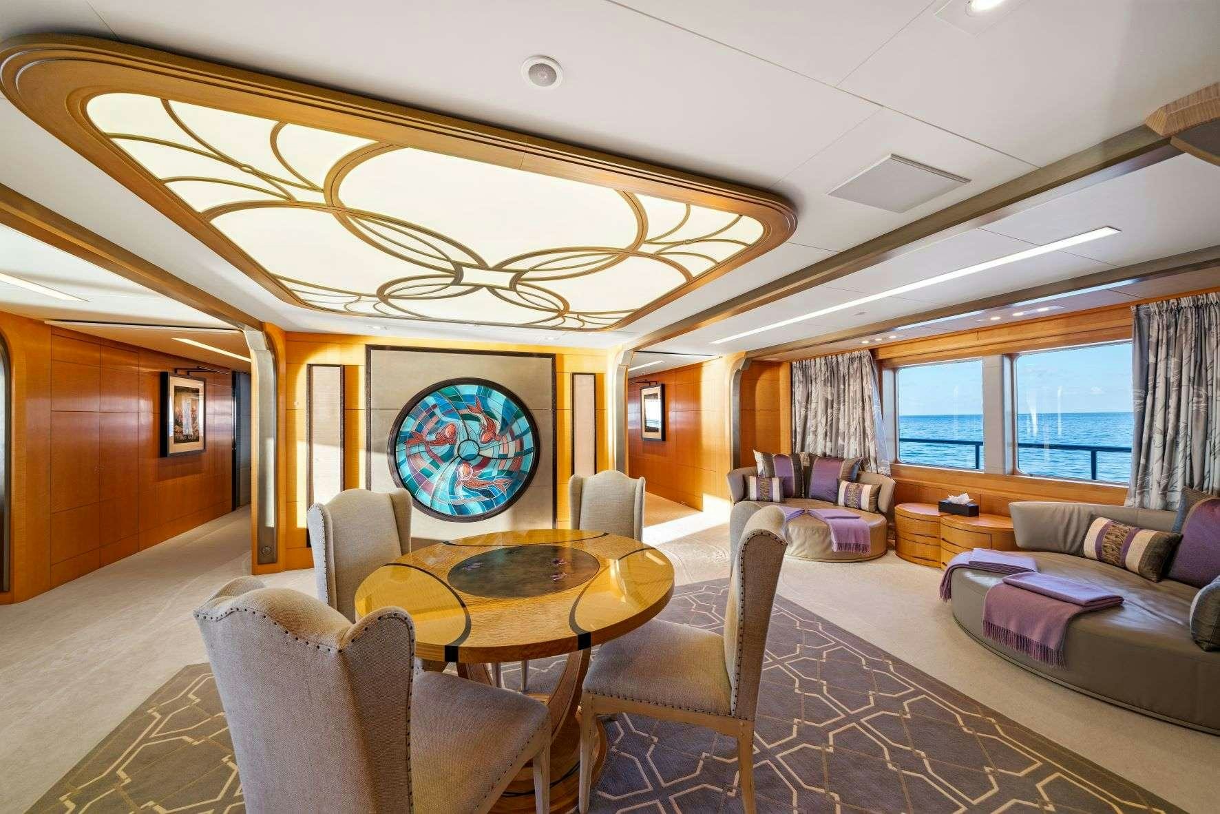 a large living room with a large chandelier aboard AMARYLLIS Yacht for Charter