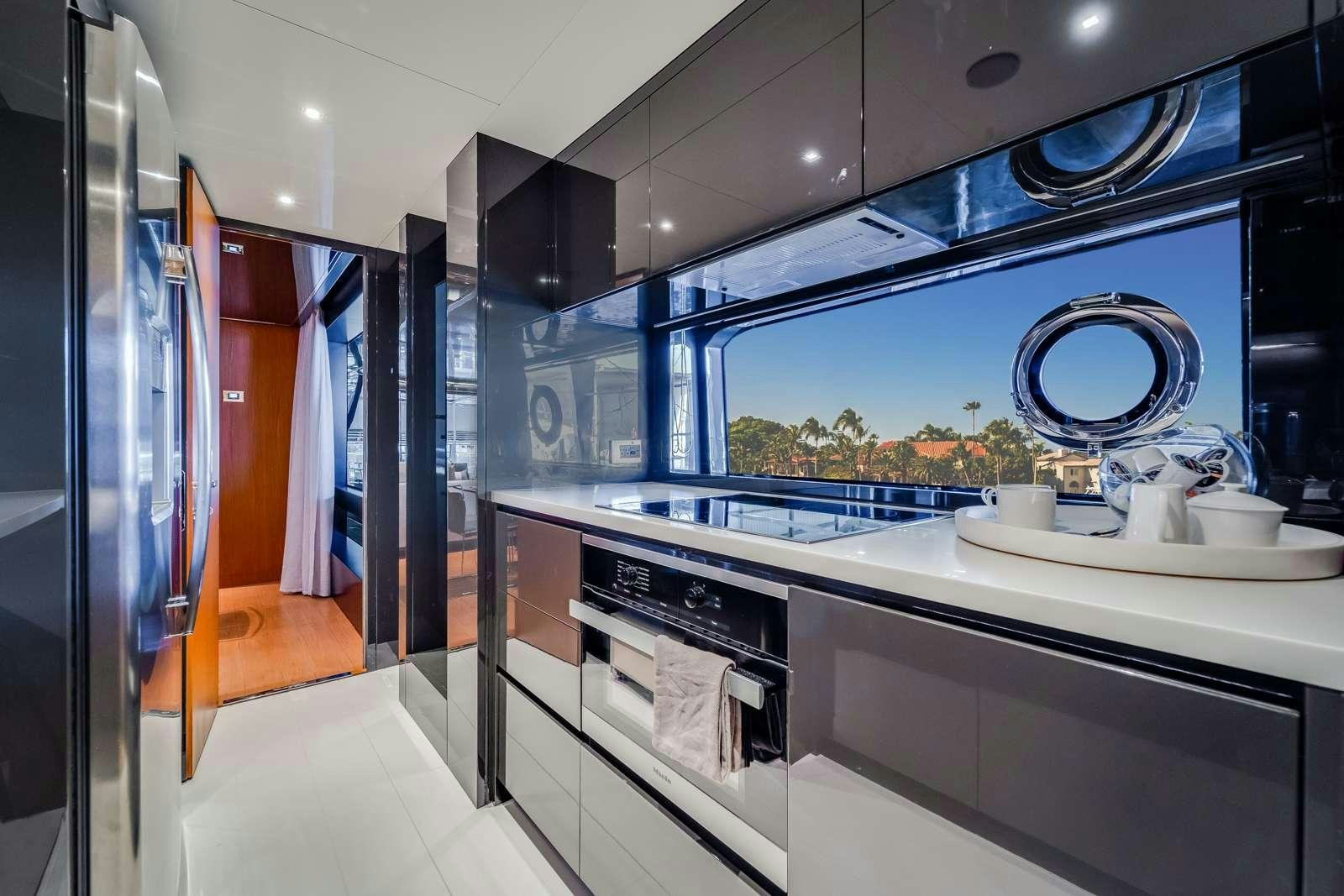 a modern kitchen with a large window aboard BEYOND BEYOND Yacht for Charter
