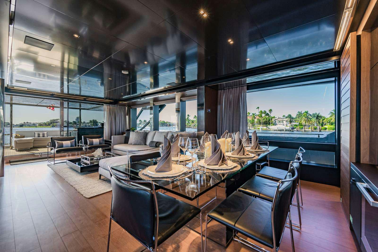 a room with a table chairs and a large window aboard BEYOND BEYOND Yacht for Charter