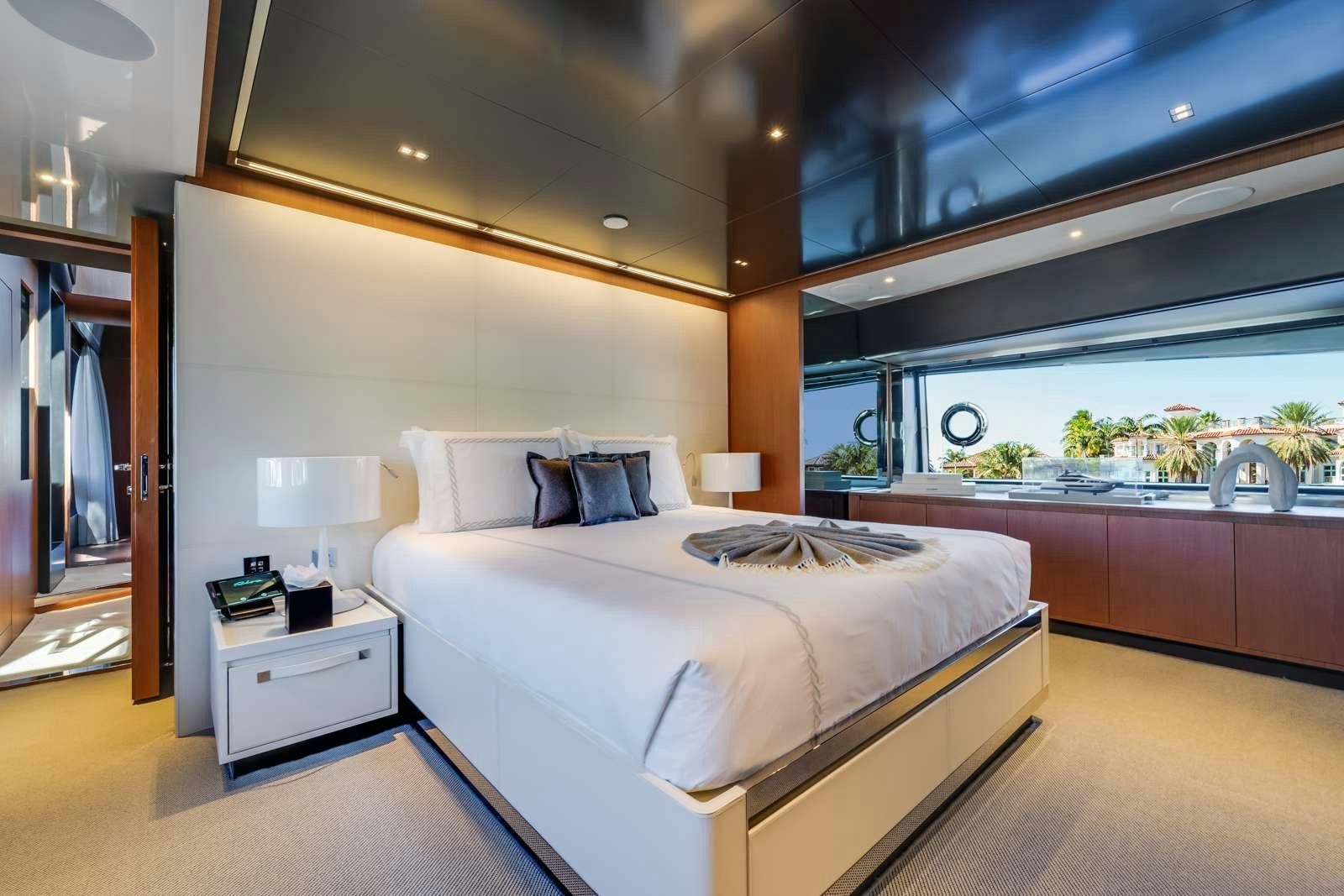 a bedroom with a large window aboard BEYOND BEYOND Yacht for Charter