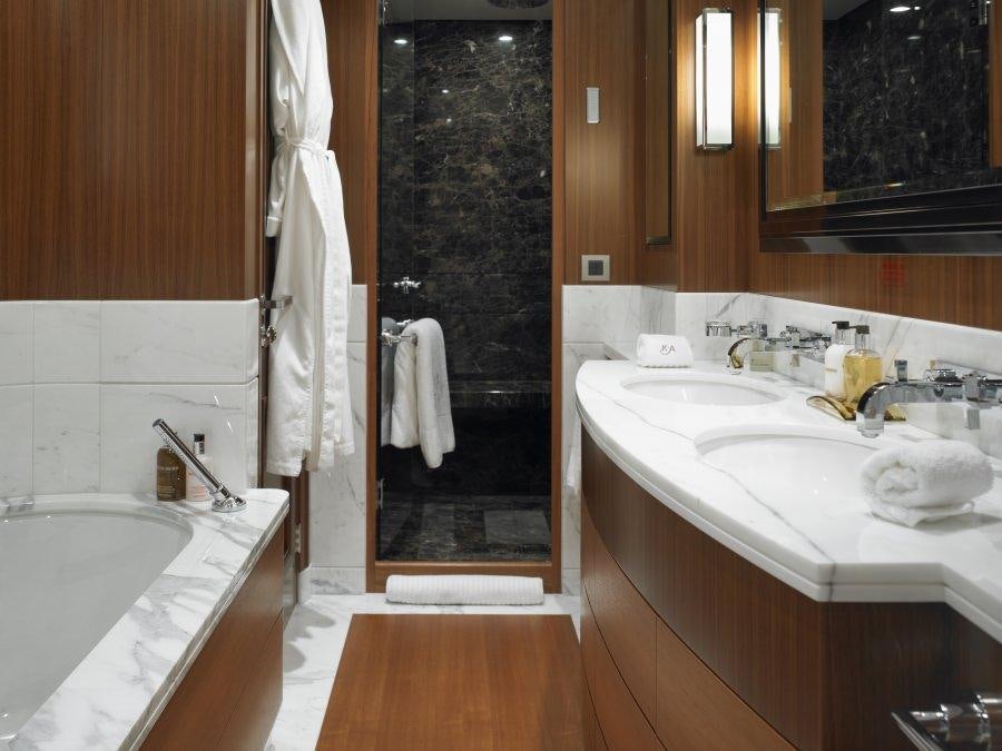 a bathroom with a tub sink and a mirror aboard KATHLEEN ANNE Yacht for Charter