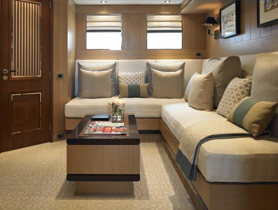 a living room with a couch and coffee table aboard KATHLEEN ANNE Yacht for Charter