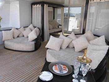 a living room with a couch and a coffee table aboard MY LITTLE VIOLET Yacht for Charter