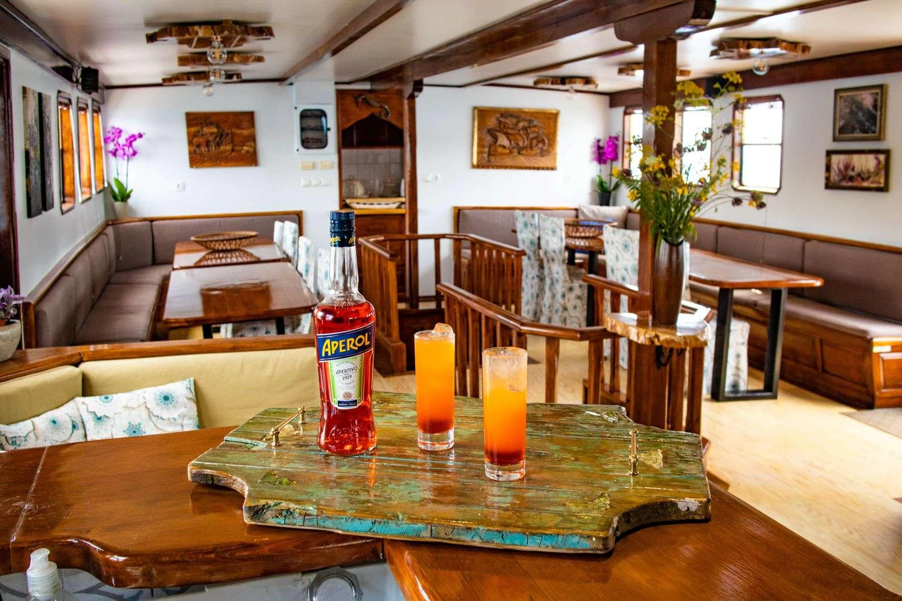 a living room with a table and chairs and a couch aboard AEGEOTISSA II Yacht for Charter