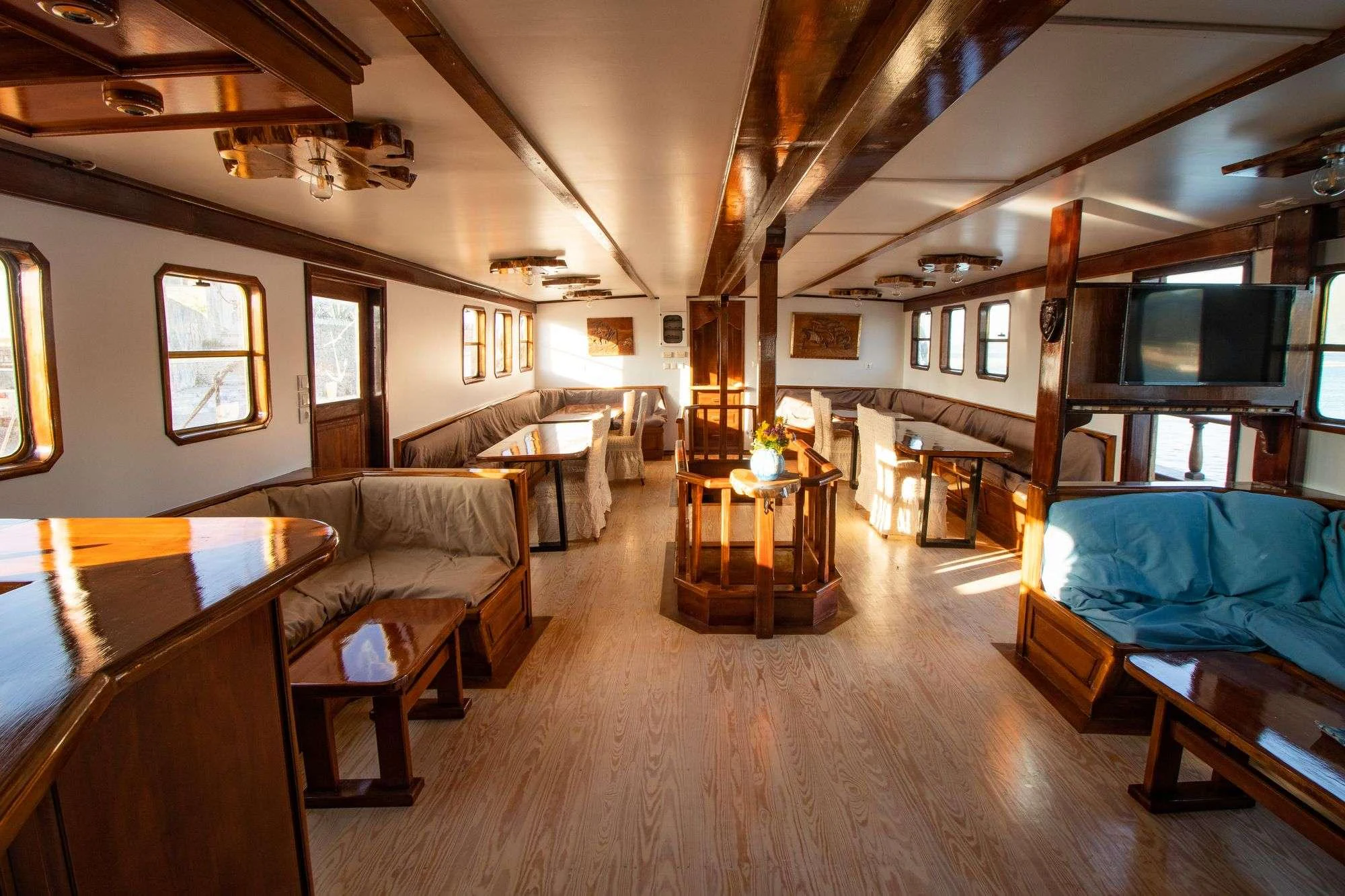 a room with a bed and a couch aboard AEGEOTISSA II Yacht for Charter