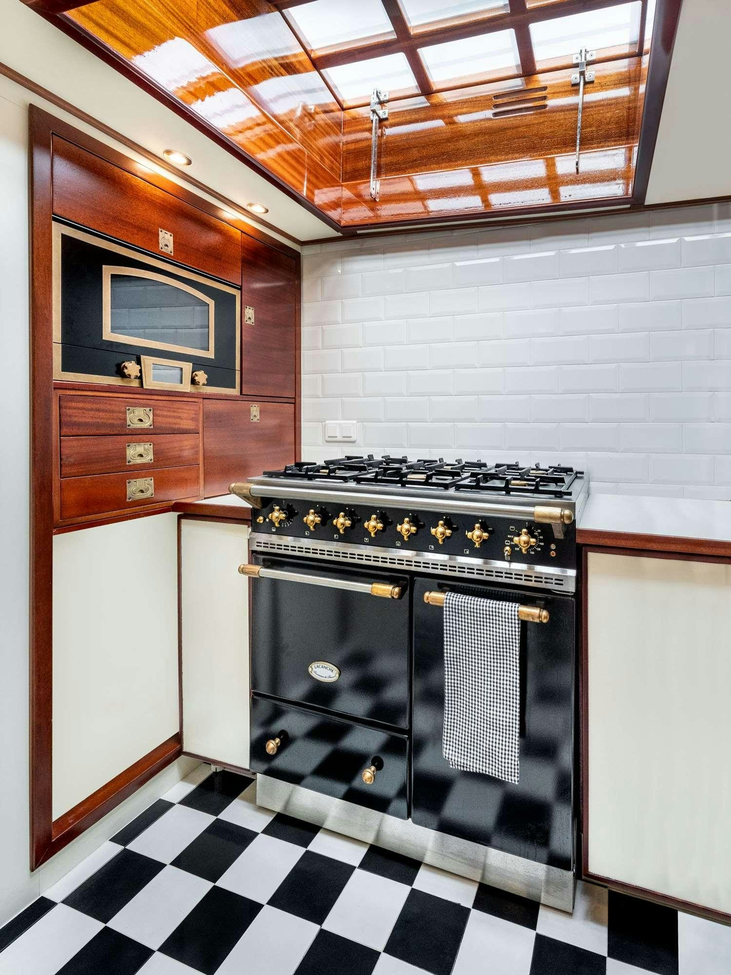 a kitchen with a stove and oven aboard WEATHER BIRD Yacht for Charter
