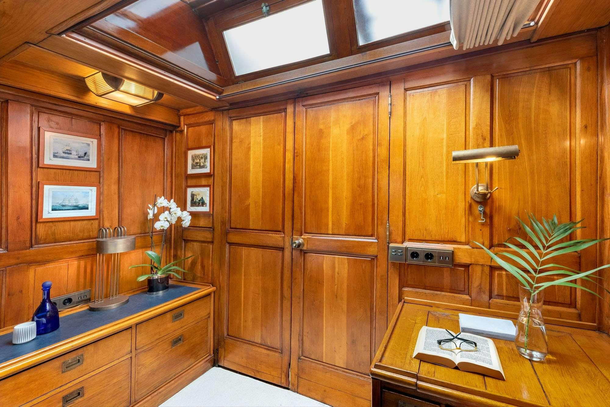a wooden cabinet with a plant in it aboard WEATHER BIRD Yacht for Charter
