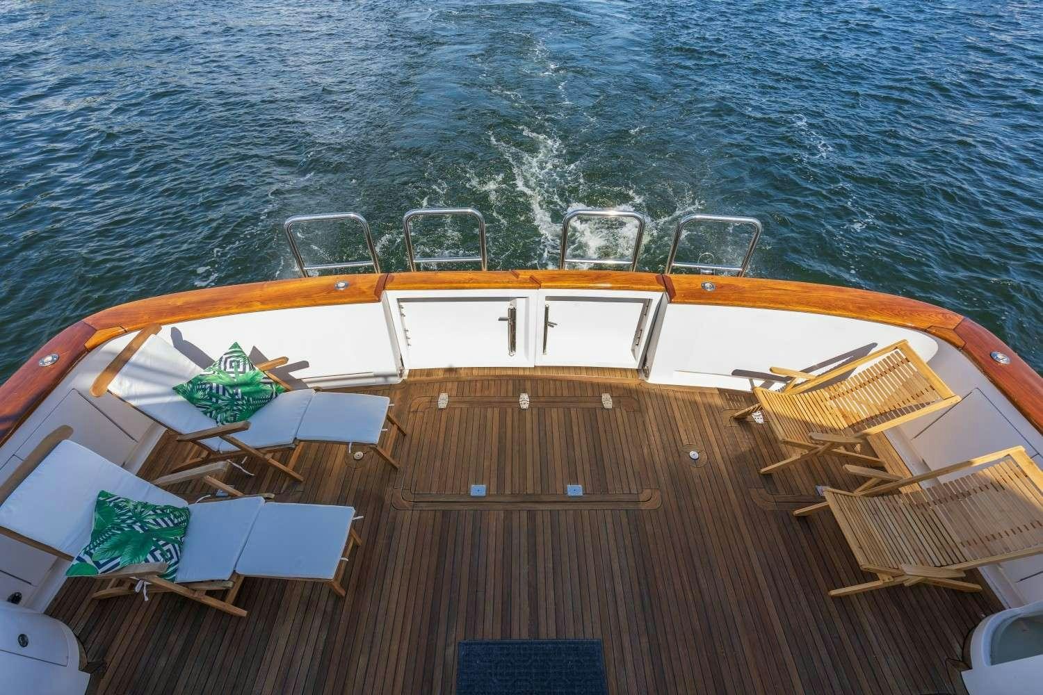 a deck with chairs and tables on it by the water aboard SEAS TO SEE Yacht for Charter