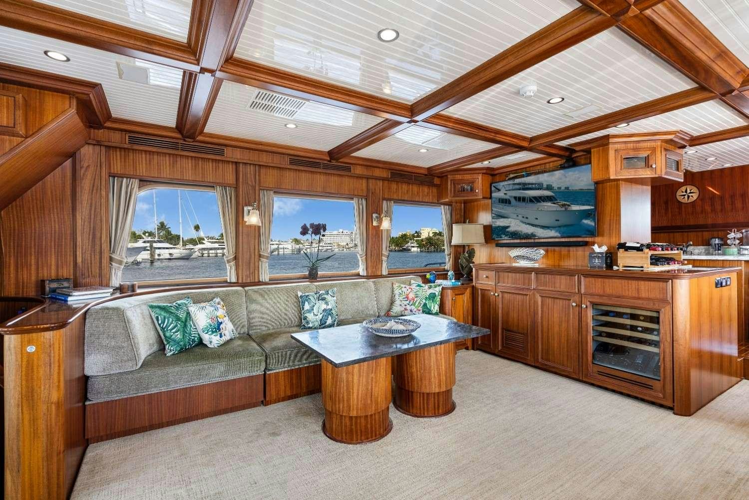 a living room with a couch and a table aboard SEAS TO SEE Yacht for Charter