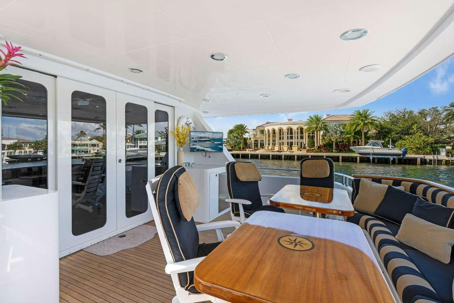 a large boat with a table and chairs on it aboard SEAS TO SEE Yacht for Charter