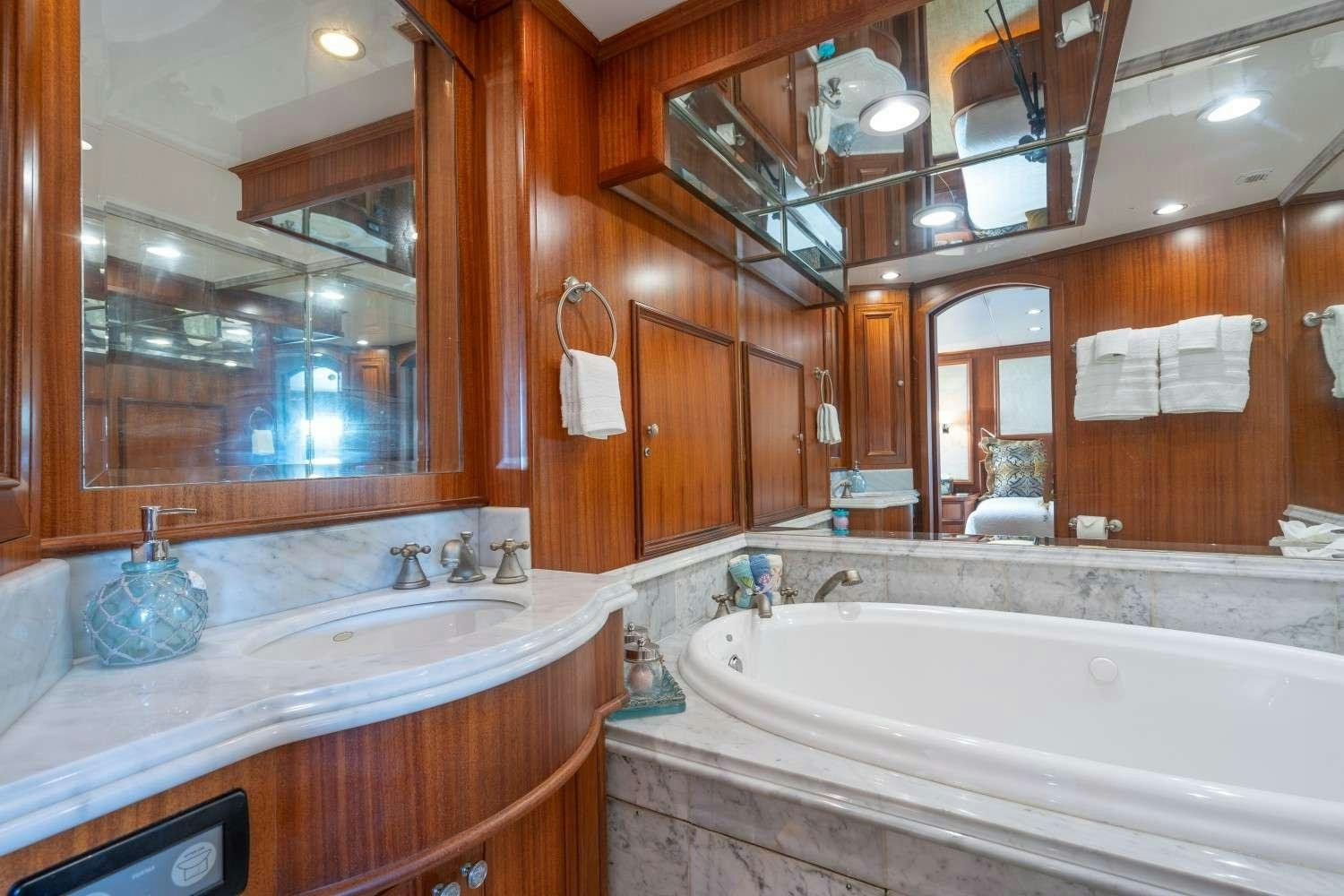 a bathroom with a large mirror aboard SEAS TO SEE Yacht for Charter