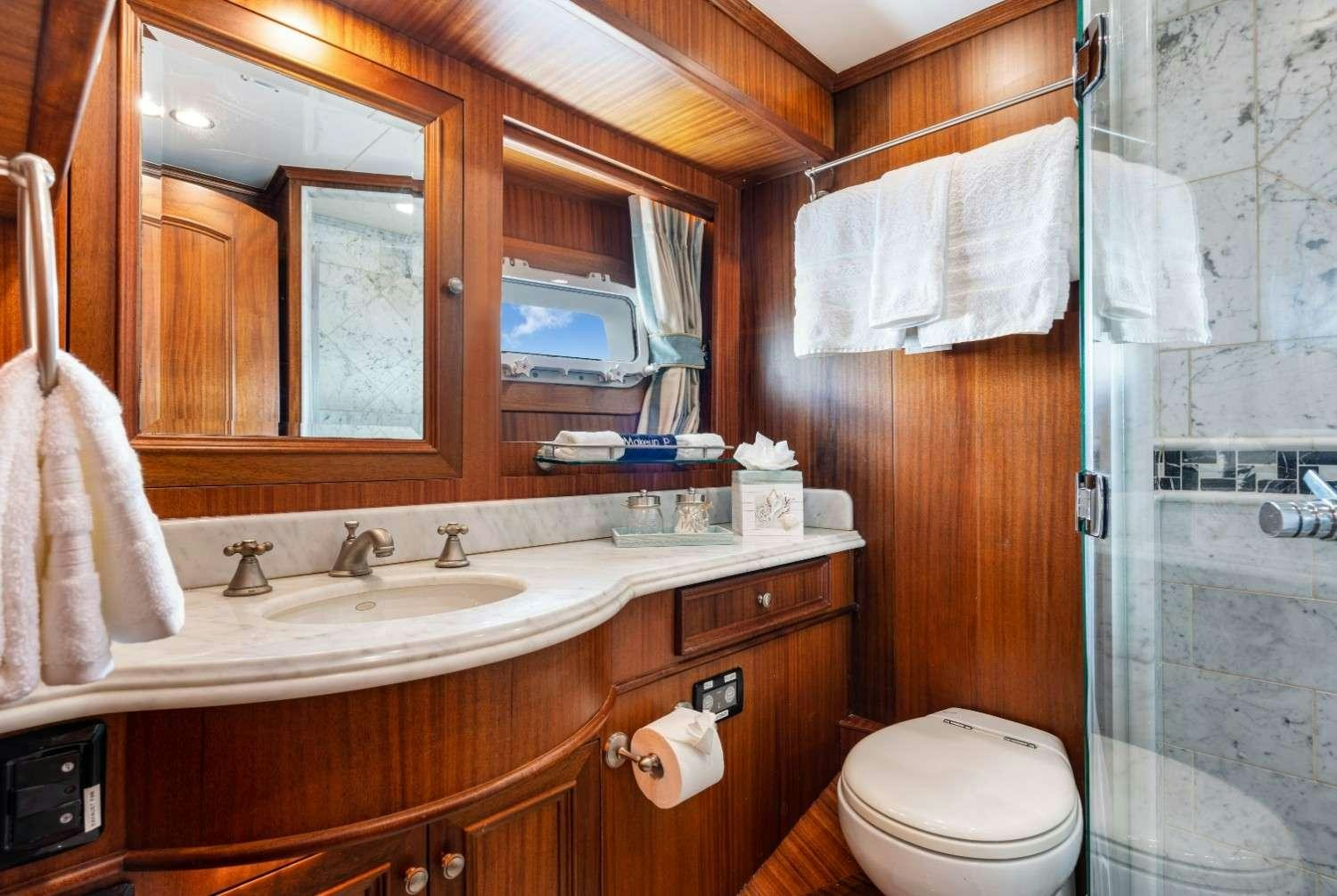 a bathroom with a sink toilet and a mirror aboard SEAS TO SEE Yacht for Charter