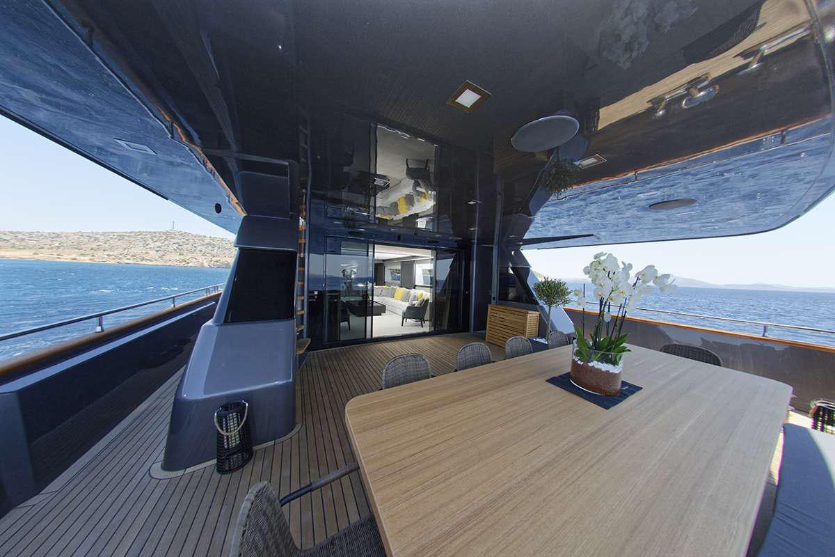 a room with a table and a view of the water aboard NOEMA Yacht for Charter