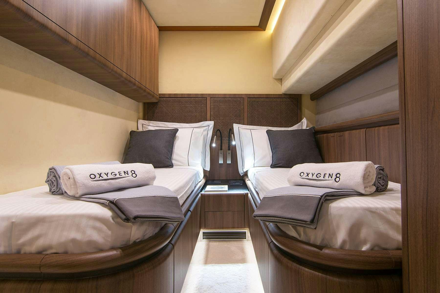 a room with beds and a wood wall aboard OXYGEN 8 Yacht for Charter