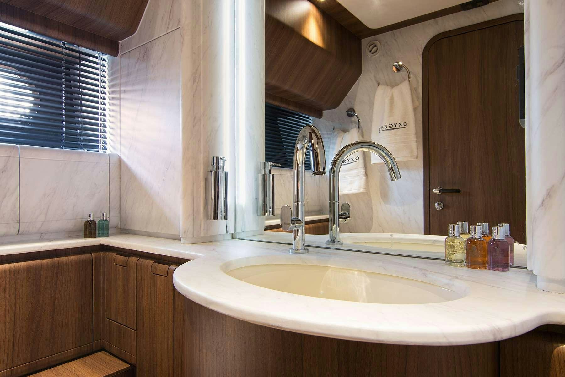 a bathroom with a sink and a mirror aboard OXYGEN 8 Yacht for Charter