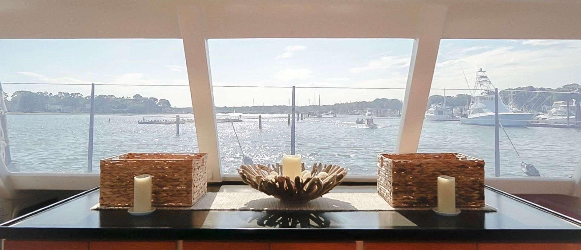 a table with food and candles aboard GAIA Yacht for Charter