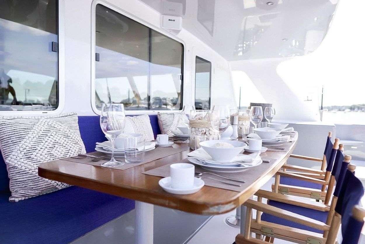 a table with plates and glasses on it aboard GAIA Yacht for Charter