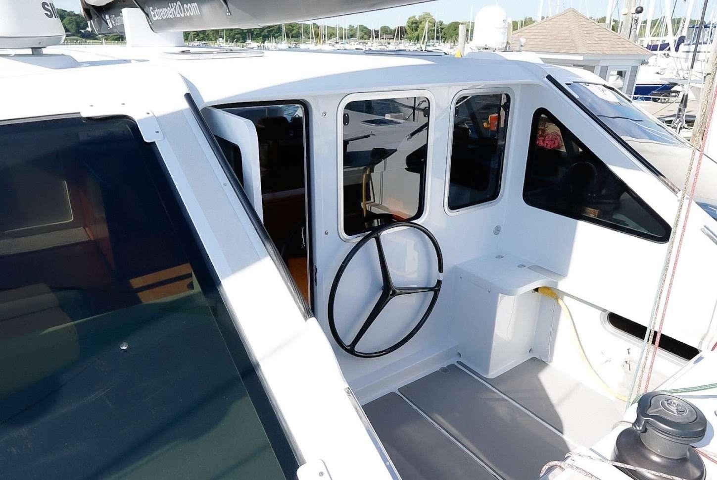 a white car with doors open aboard GAIA Yacht for Charter
