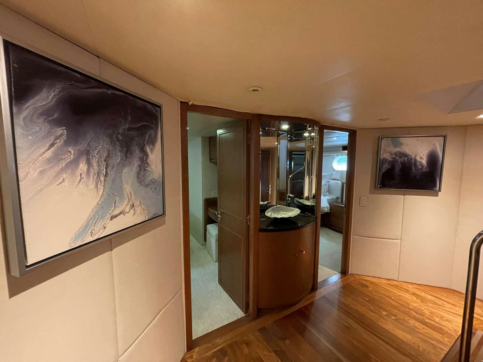 a room with a mirror and a wood floor aboard TOO SHALLOW Yacht for Charter