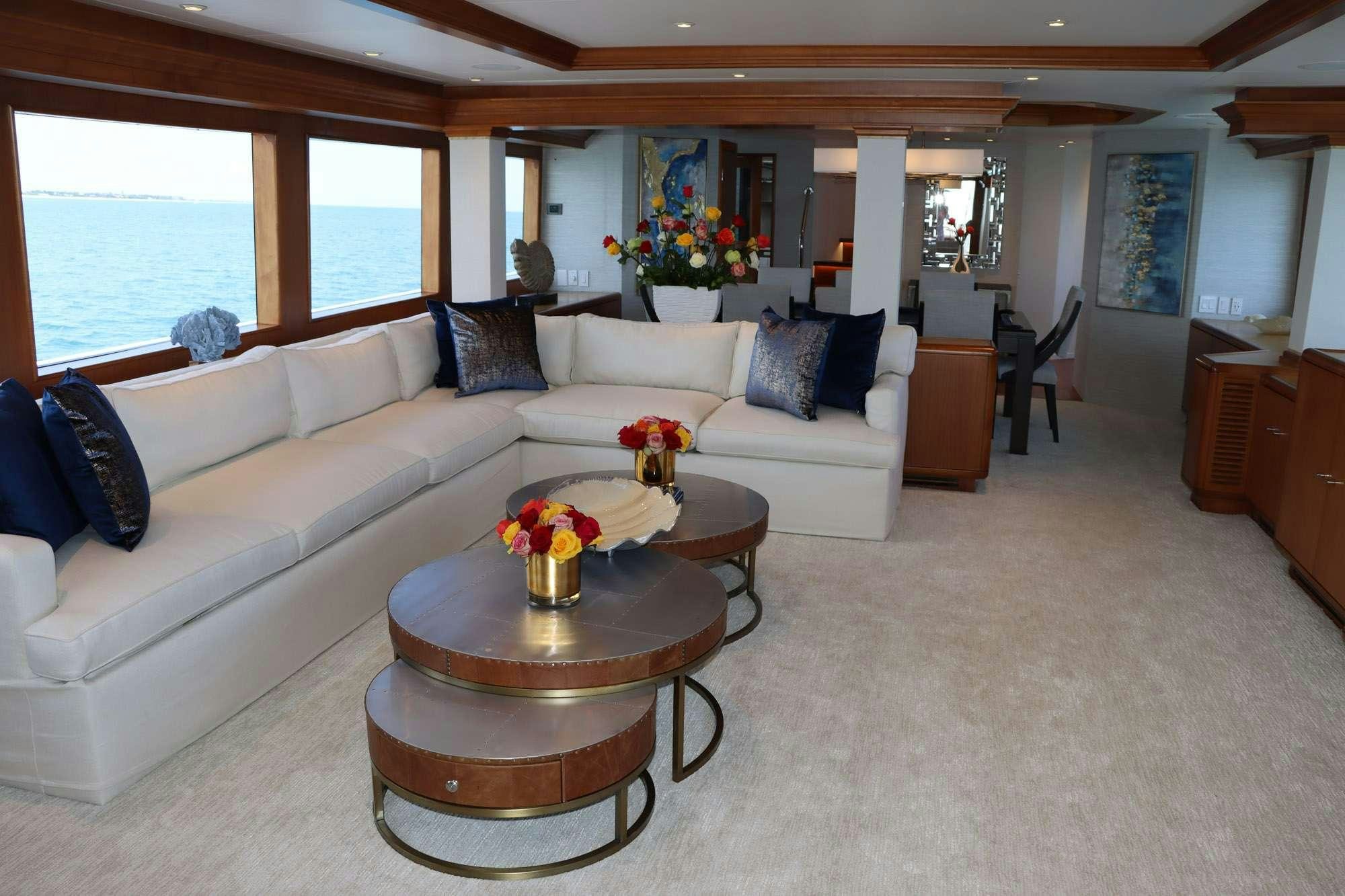 a living room with a white couch and a coffee table aboard TOO SHALLOW Yacht for Charter