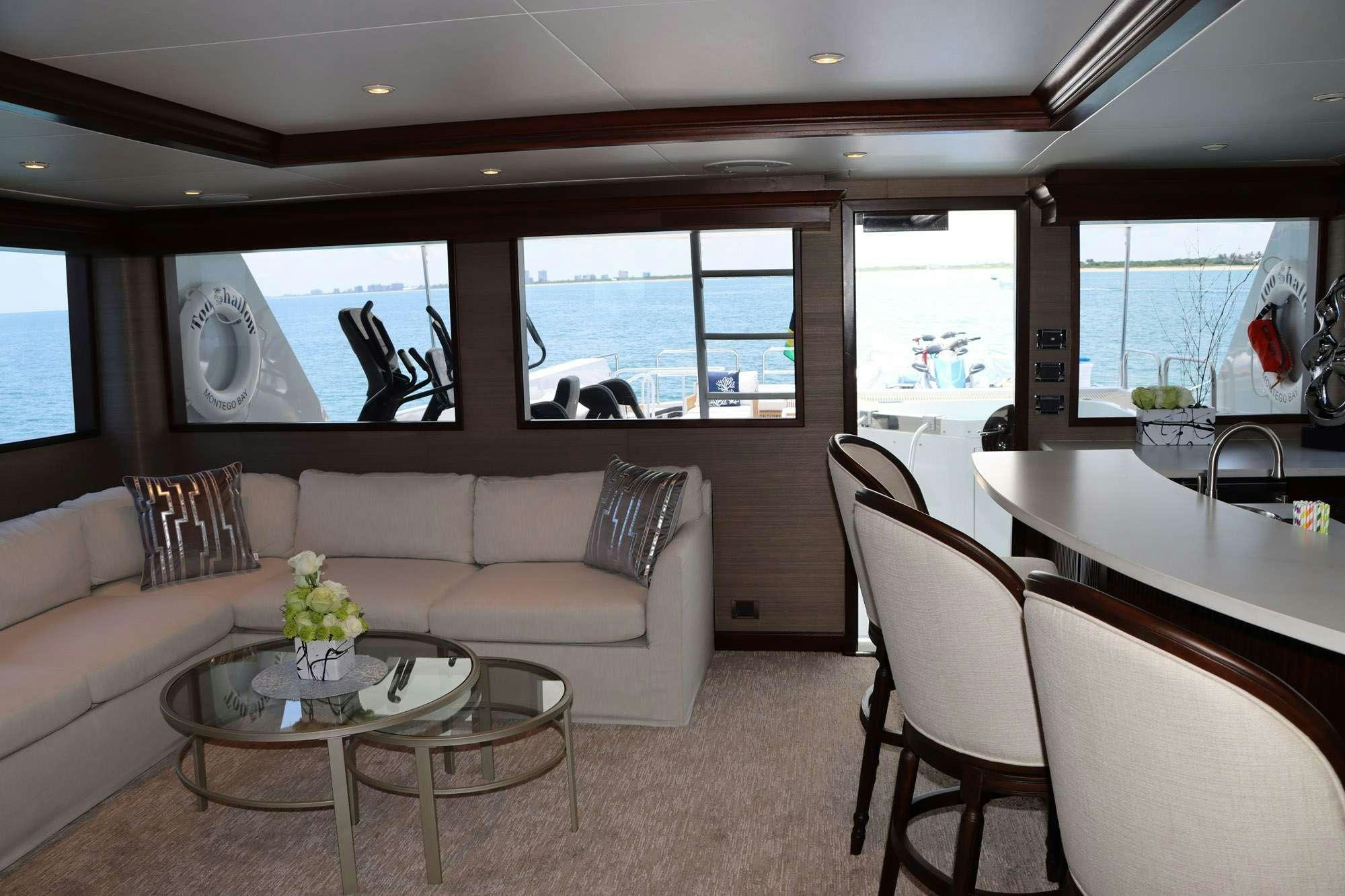 a living room with a couch and a table aboard TOO SHALLOW Yacht for Charter
