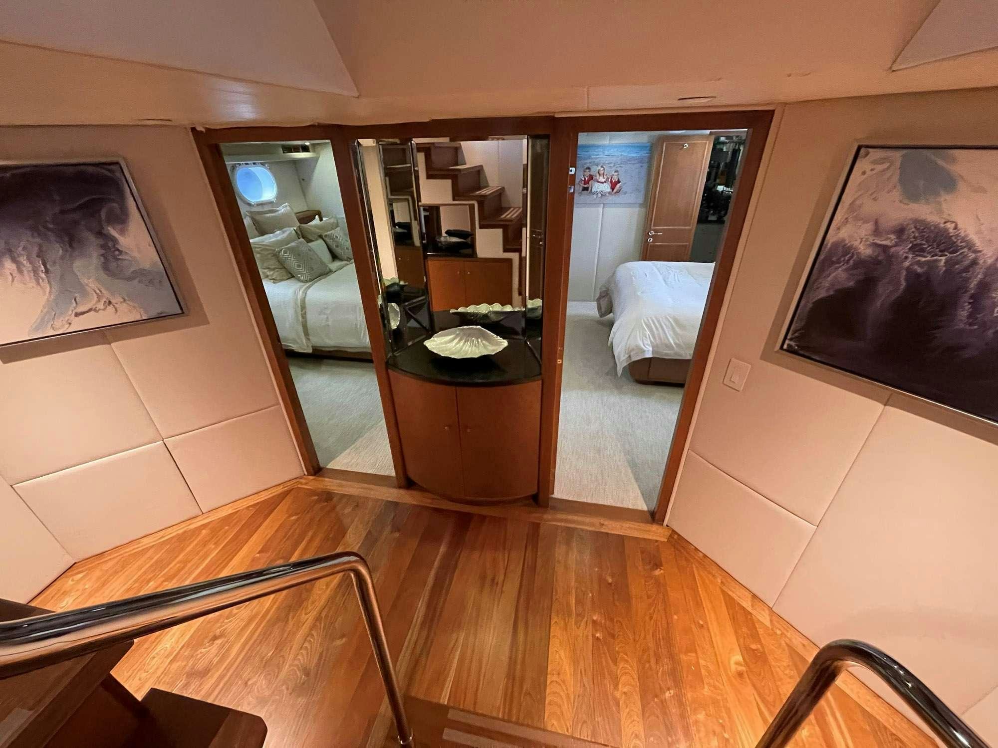 a room with a wood floor and a large mirror aboard TOO SHALLOW Yacht for Charter
