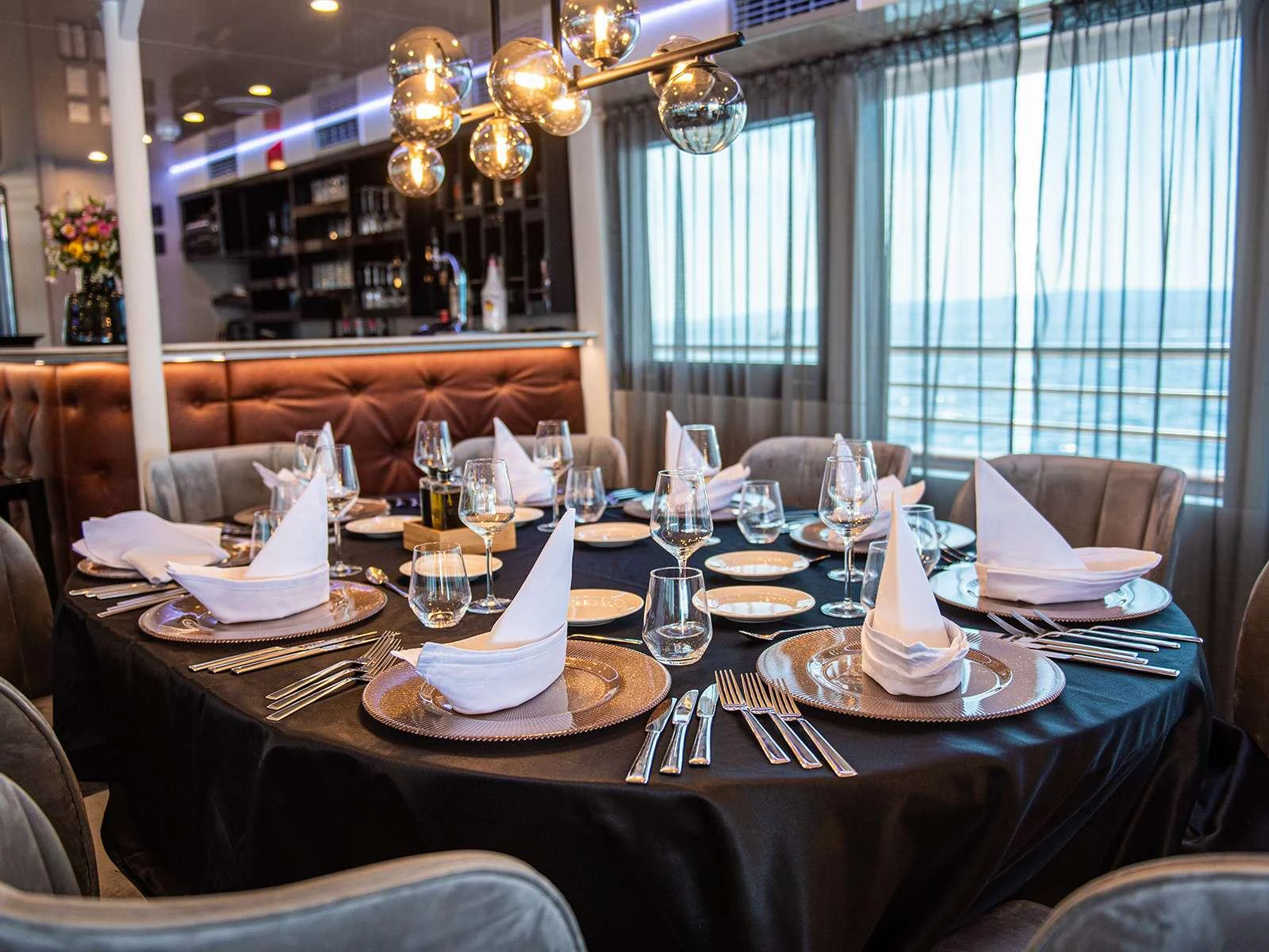 a table set with plates and glasses aboard ALFA MARIO Yacht for Charter
