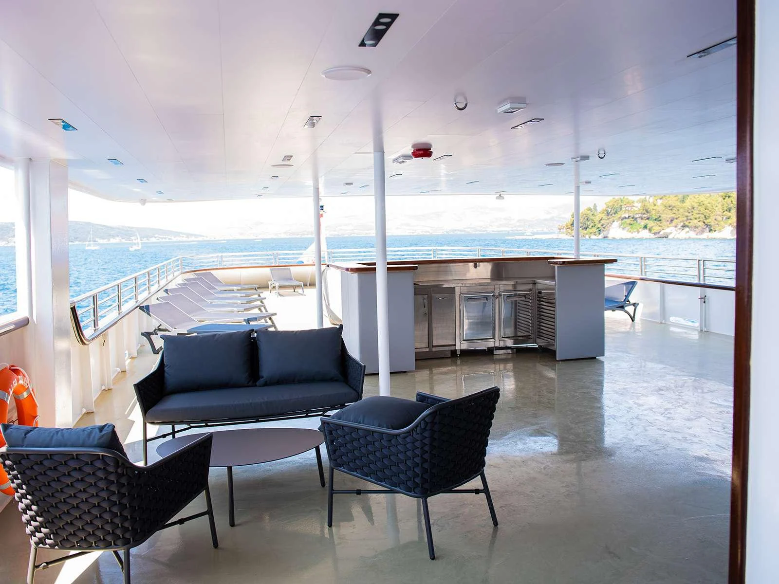 a room with a couch and a table and chairs aboard ALFA MARIO Yacht for Charter