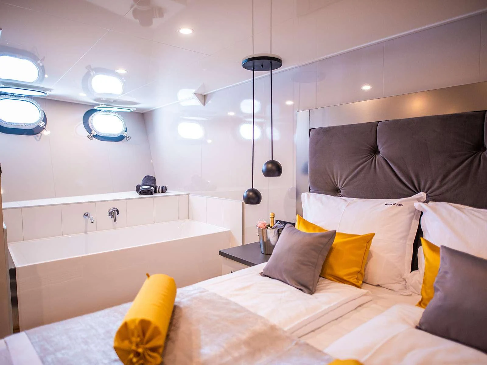 a bed with a white bed aboard ALFA MARIO Yacht for Charter
