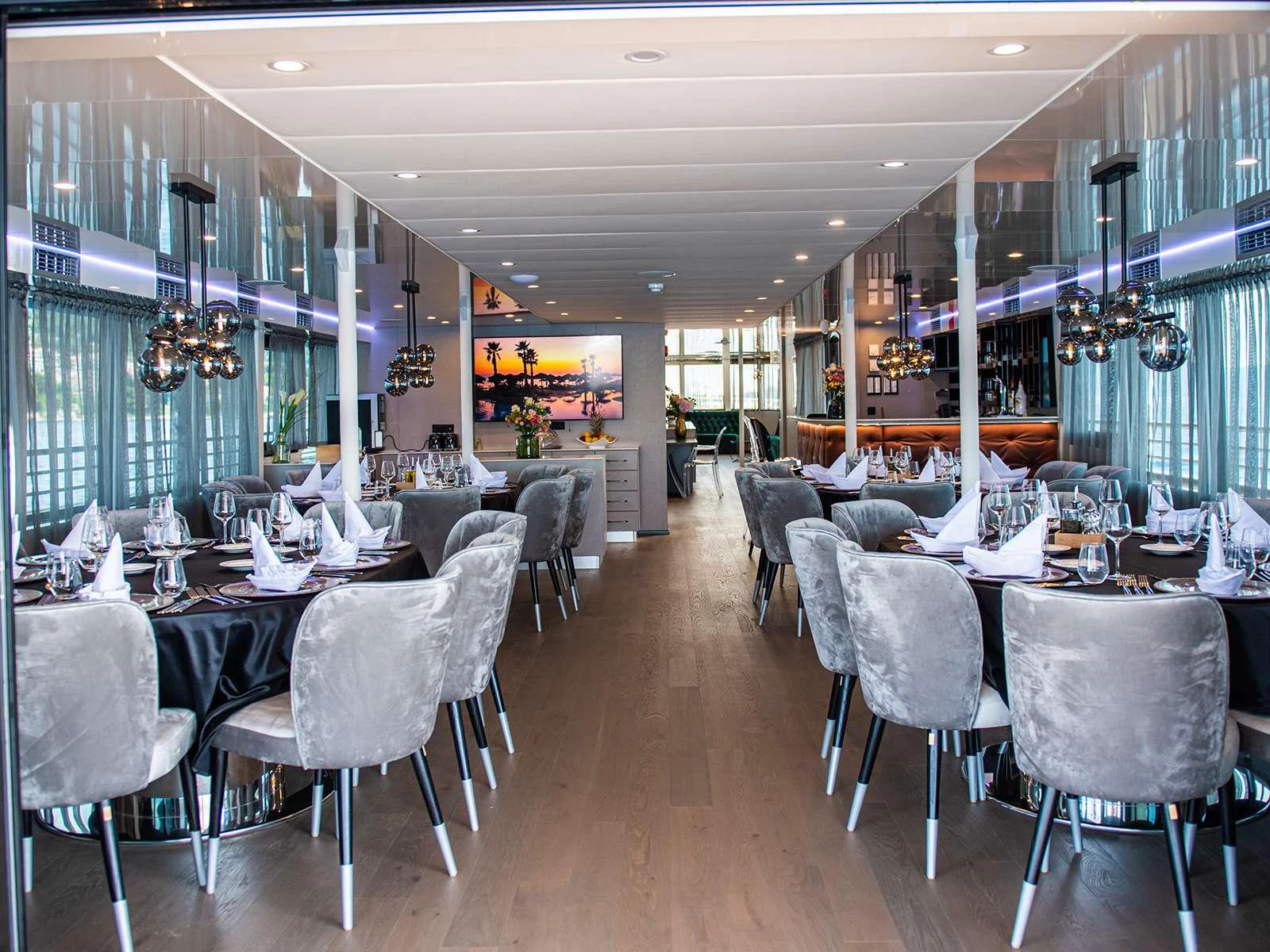 a room with tables and chairs aboard ALFA MARIO Yacht for Charter