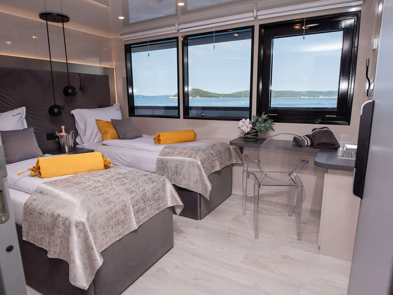 a room with two beds and a tv aboard ALFA MARIO Yacht for Charter