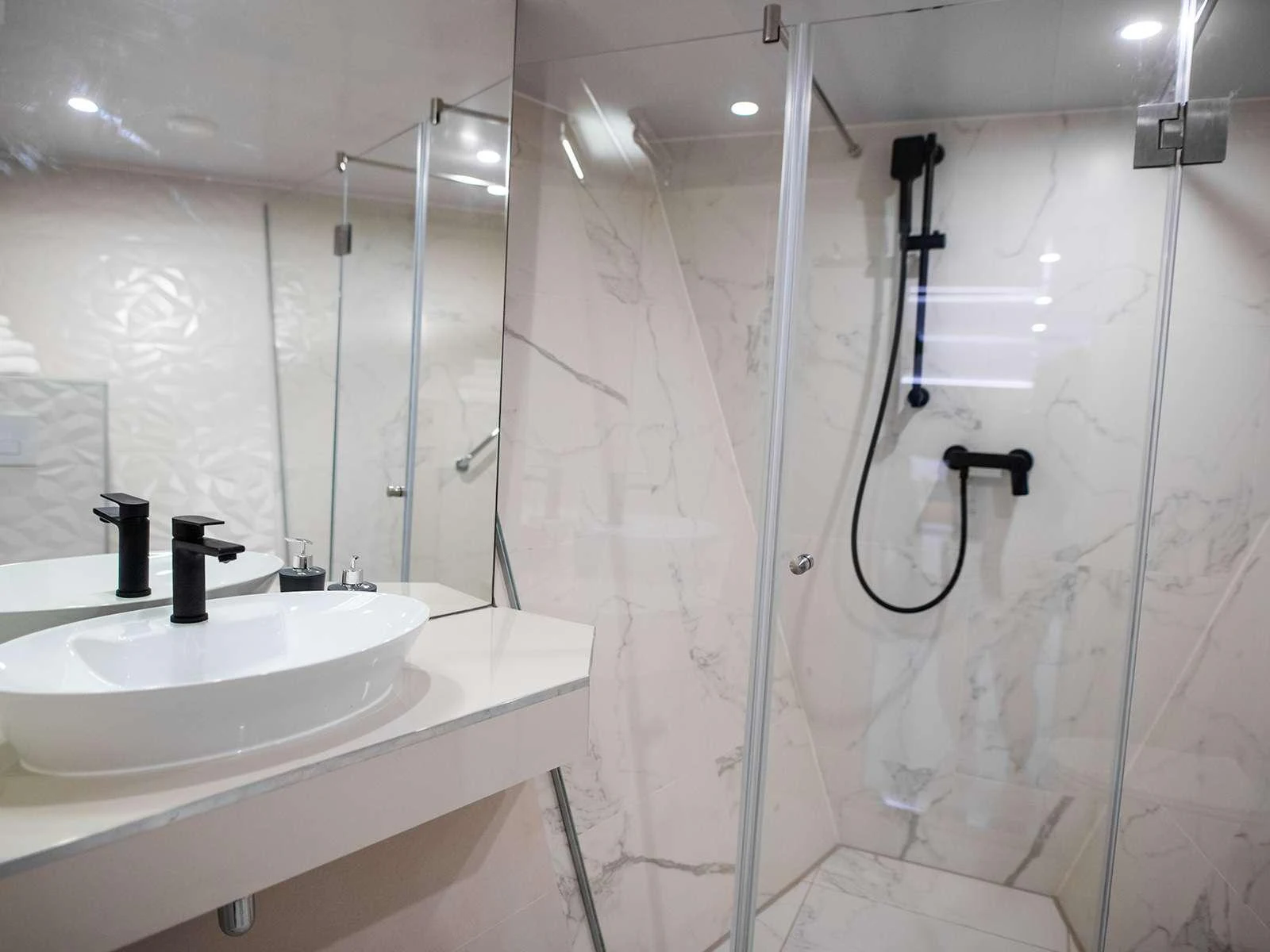 a bathroom with a shower and sink aboard ALFA MARIO Yacht for Charter