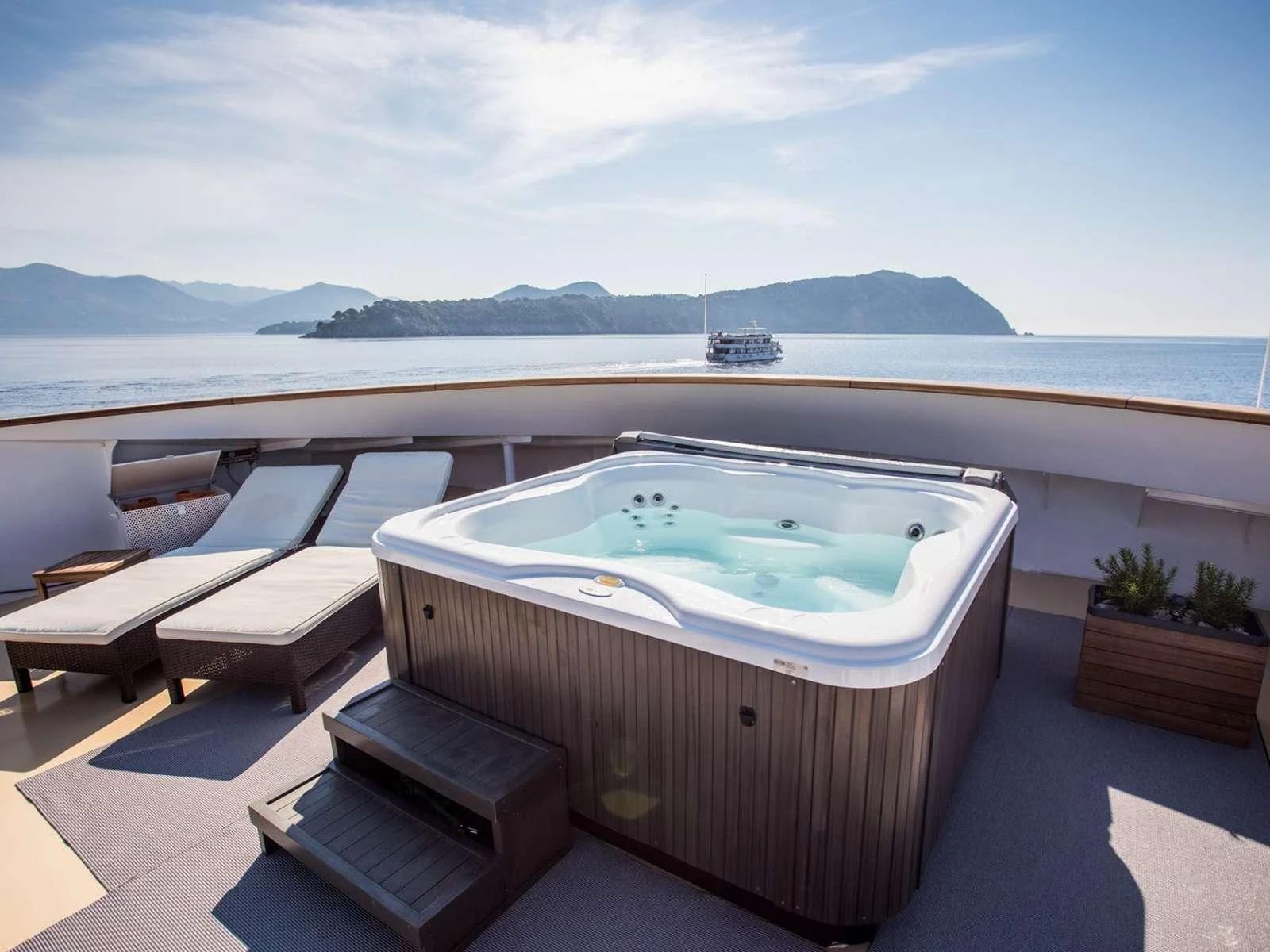 a pool with a boat in the background aboard KARIZMA Yacht for Charter