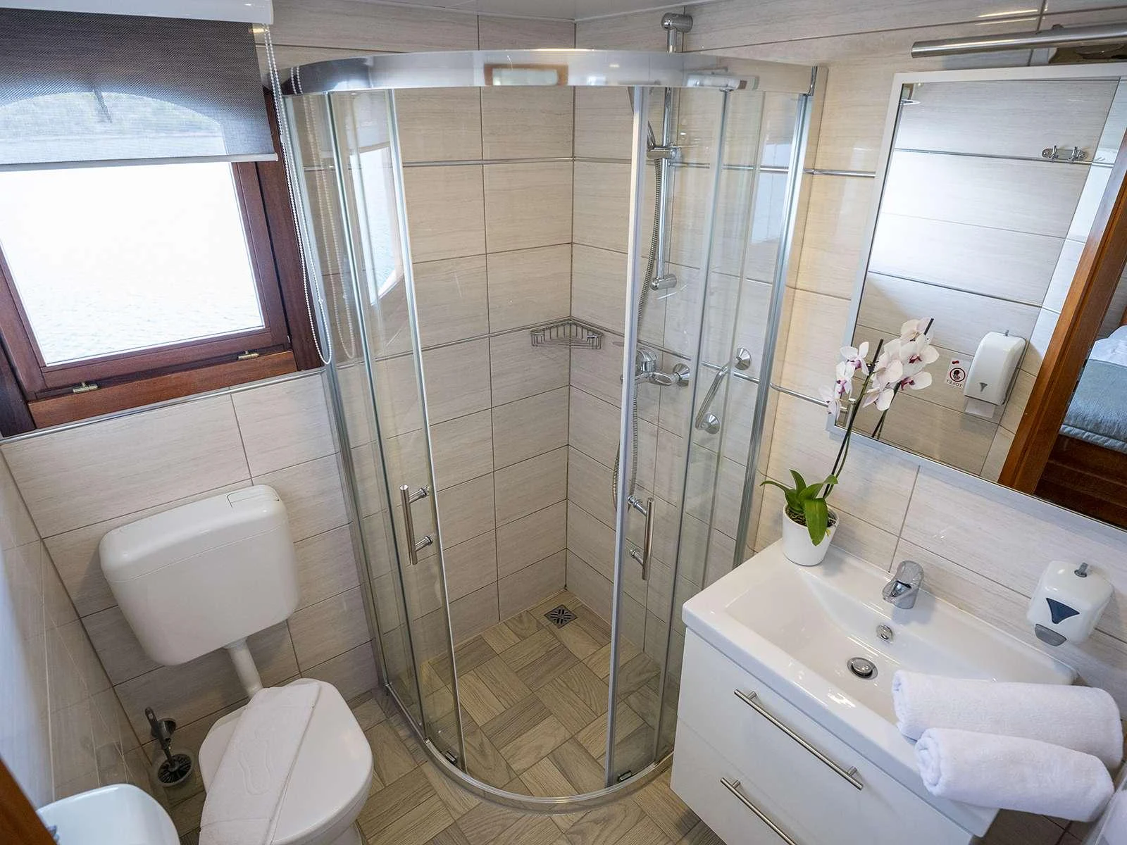 a bathroom with a glass shower aboard KARIZMA Yacht for Charter