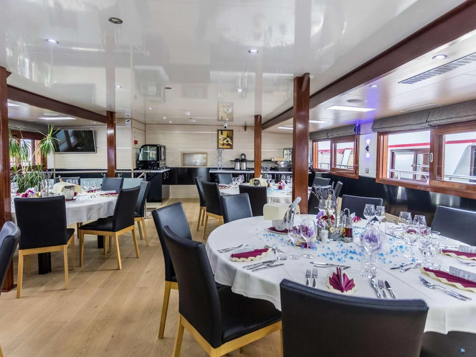 a restaurant with tables and chairs aboard KARIZMA Yacht for Charter