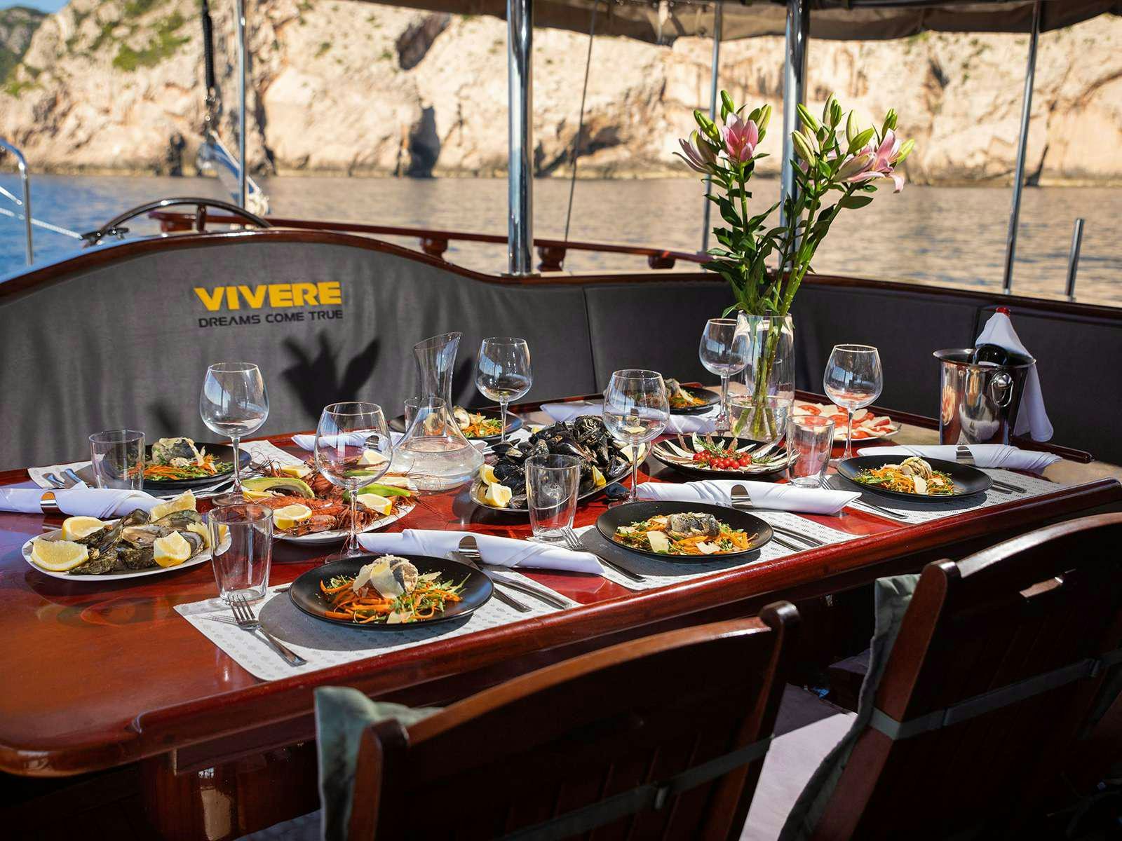 a table with plates and glasses on it aboard DALMATINO Yacht for Charter