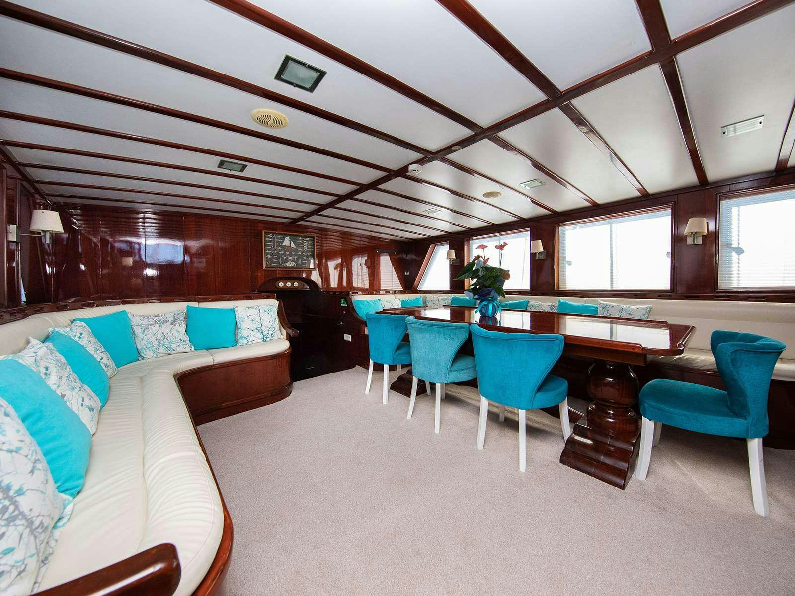 a room with a couch and a table and chairs aboard DALMATINO Yacht for Charter