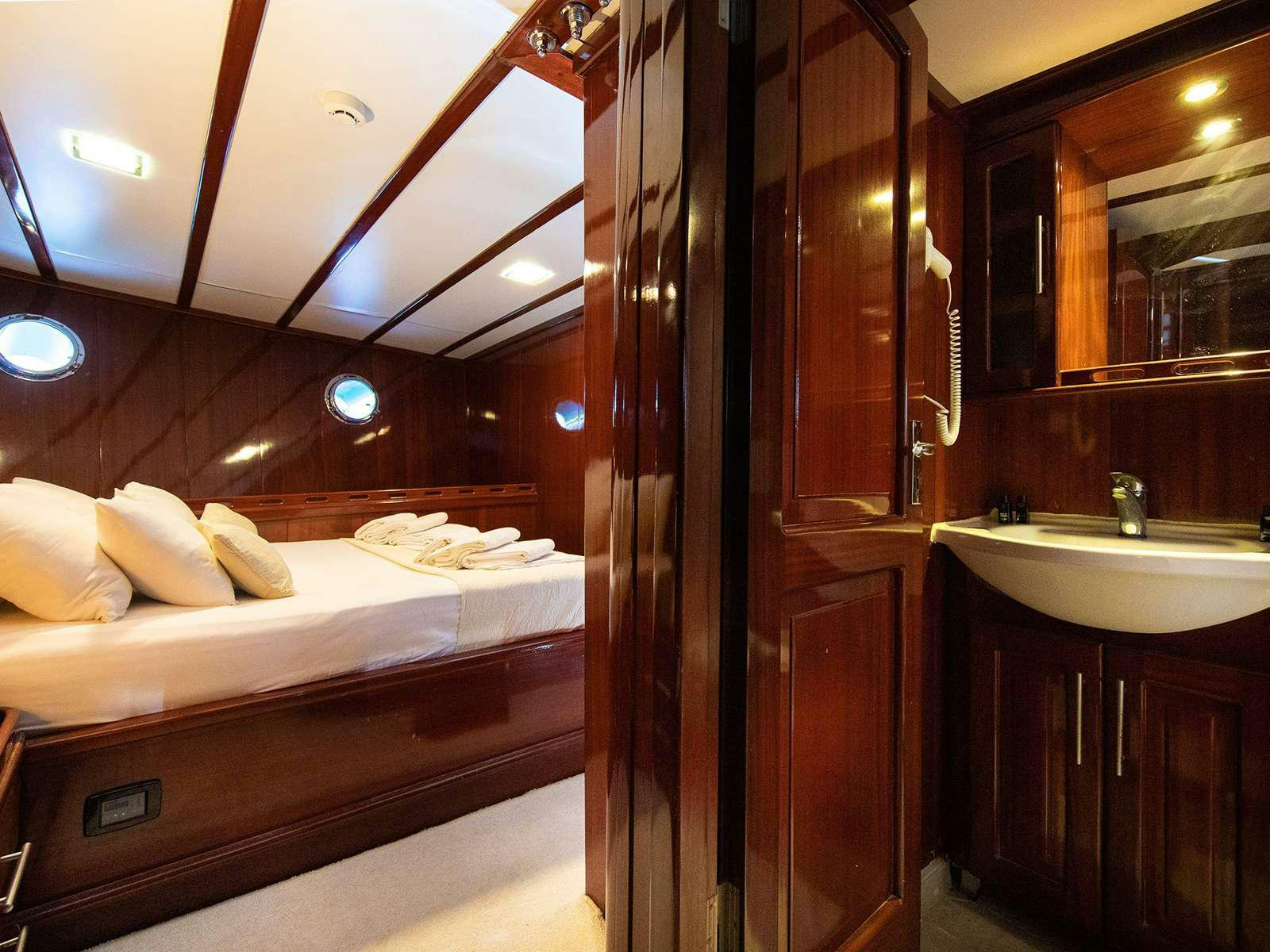 a bathroom with a bed and a sink aboard DALMATINO Yacht for Charter