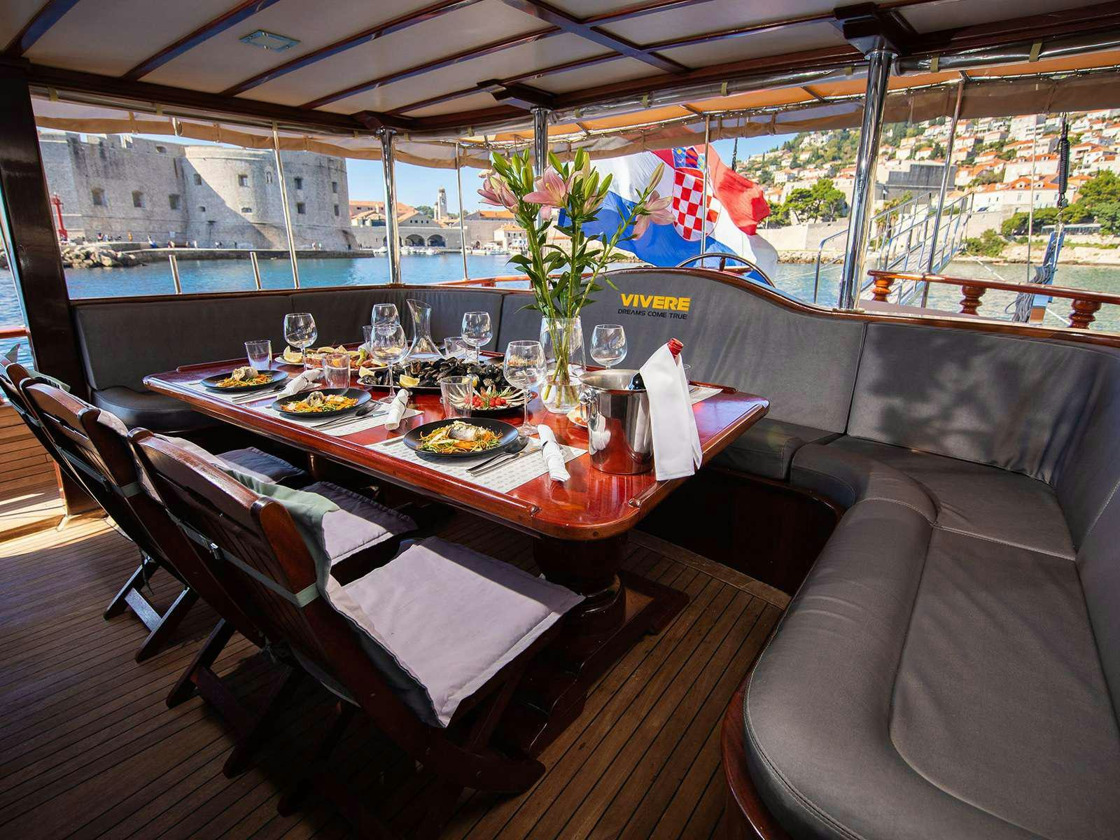 a table set with food aboard DALMATINO Yacht for Charter