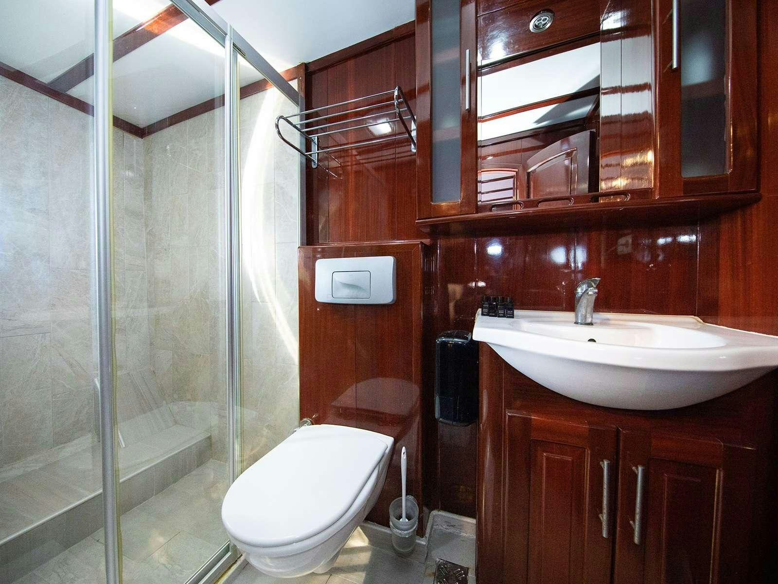 a bathroom with a glass shower aboard DALMATINO Yacht for Charter
