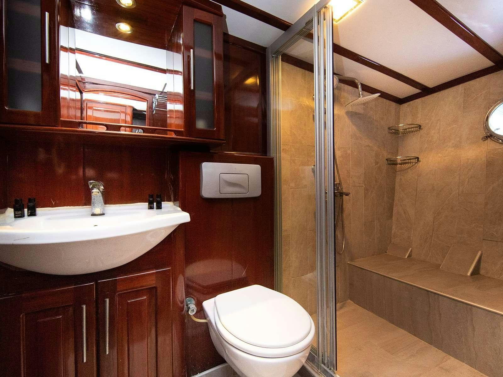 a bathroom with a glass shower aboard DALMATINO Yacht for Charter