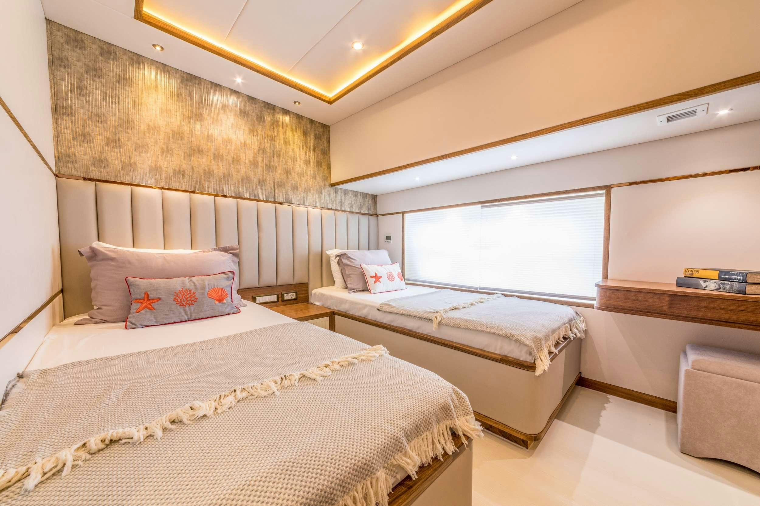 a couple of beds in a room aboard FLOKI Yacht for Charter