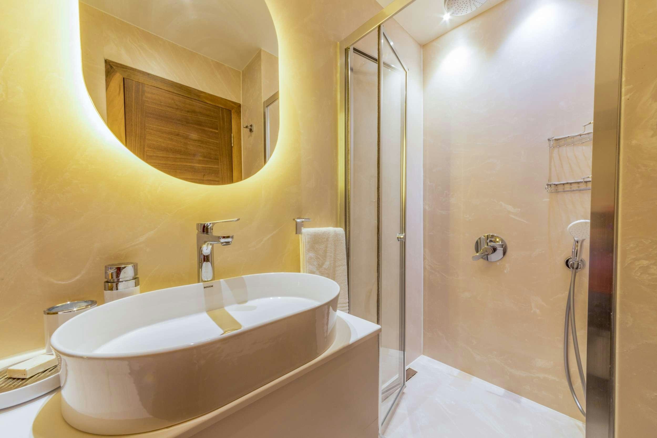 a bathroom with a bathtub and sink aboard FLOKI Yacht for Charter