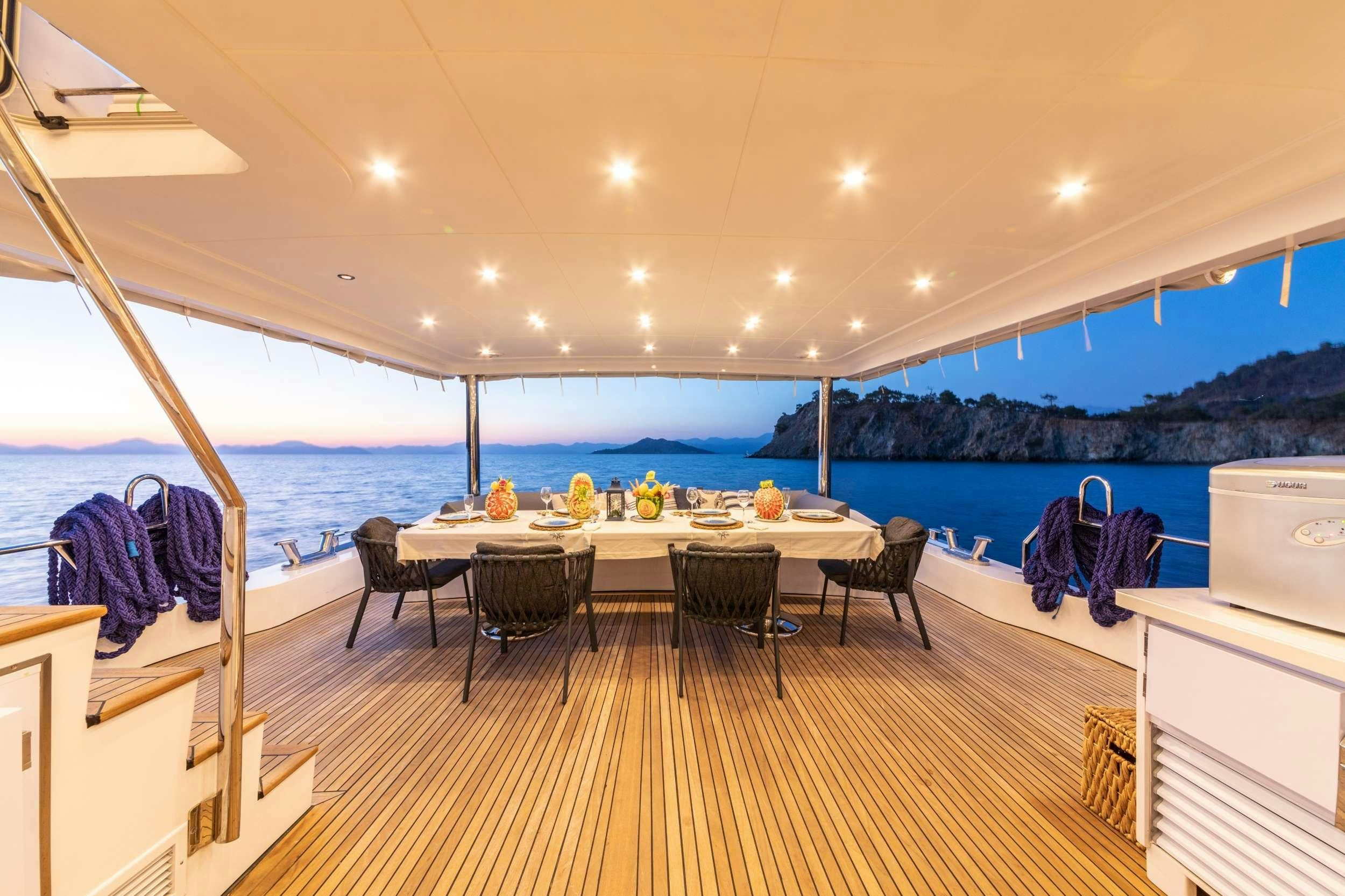 a large dining table with a view of the ocean aboard FLOKI Yacht for Charter